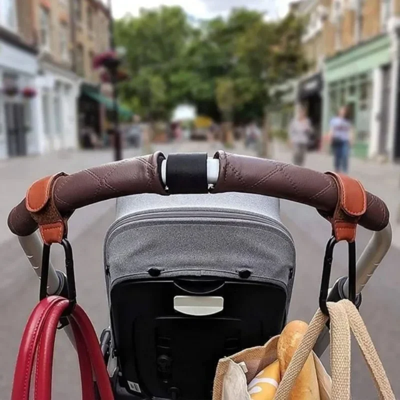 Gancho giratorio con bolsa de almacenamiento para cochecito de bebé